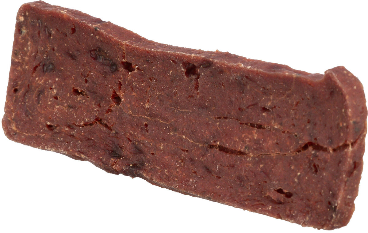 Ein rechteckiges, dickes, dunkelbraunes Stück mit rauer Textur und ungleichmäßiger Oberfläche.