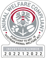 Rundes Logo mit grauem Adler, roten Akzenten und Text "Animal Welfare Compliant" und "Inspection Number 202212022".