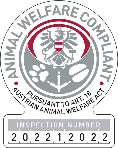 Rundes Logo mit grauem Adler, roten Akzenten und Text "Animal Welfare Compliant" und "Inspection Number 202212022".