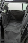 Schwarze Autoschondecke auf Rückbank eines offenen Fahrzeugs sichtbar.