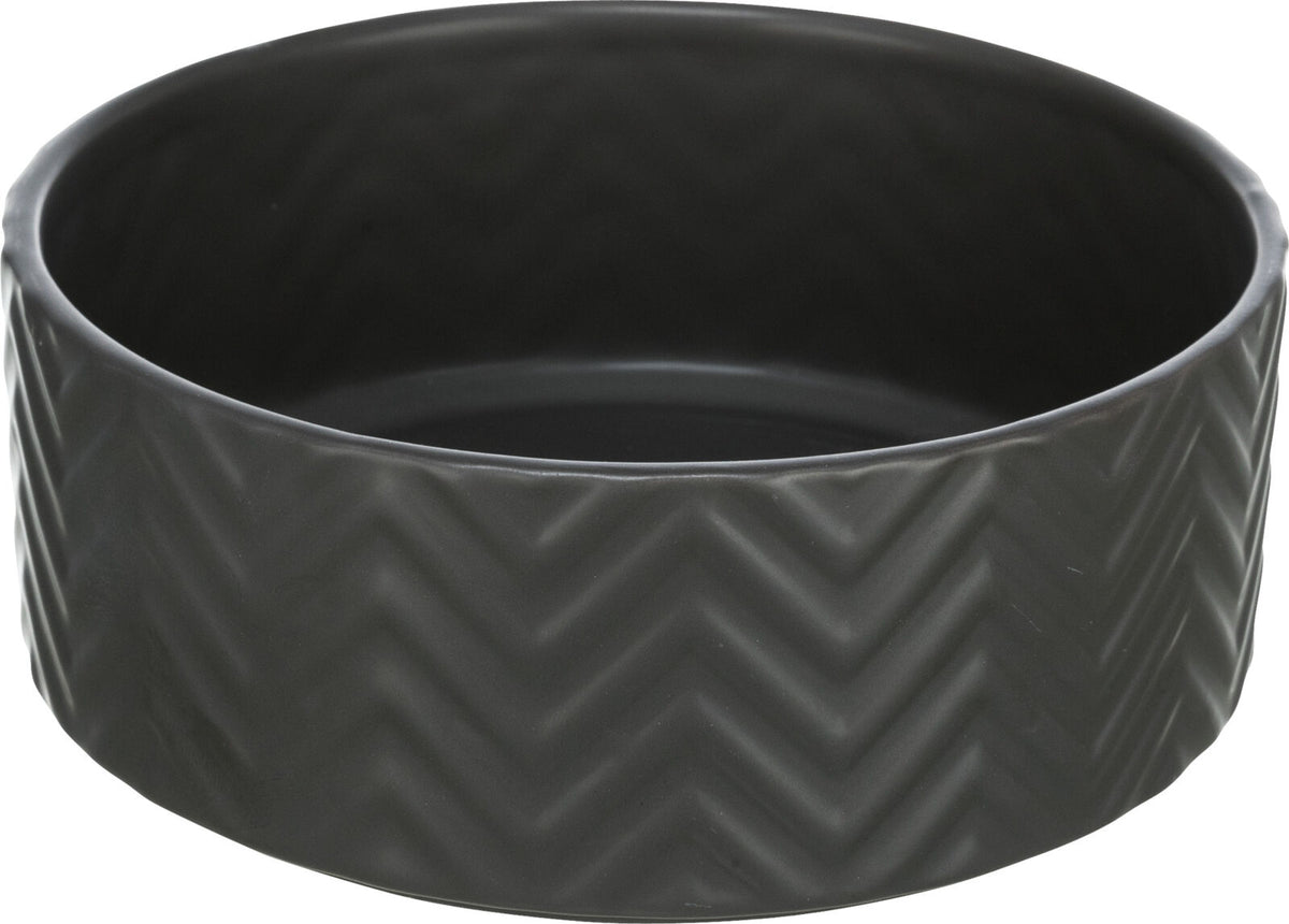 Runde, schwarze Schale mit Zickzack-Muster auf der Außenseite.