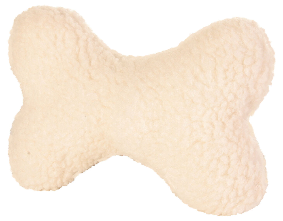 Knochenförmiges, cremefarbenes Kissen mit flauschiger Oberfläche.
