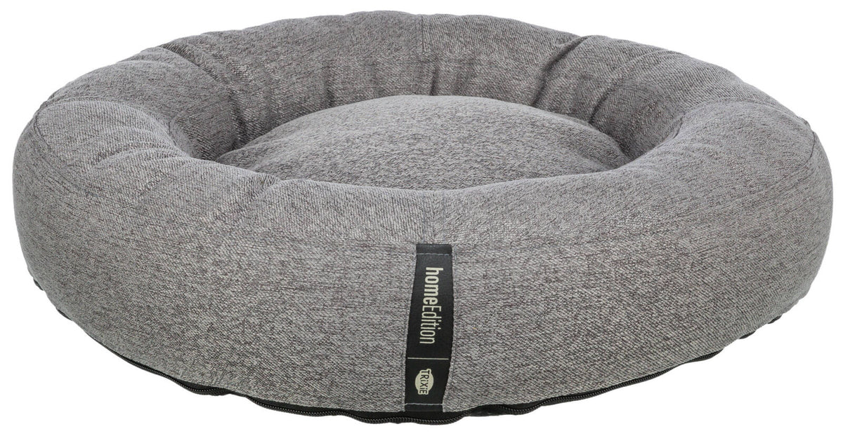 Graues, rundes Haustierbett mit schwarzem Etikett der Marke "homeEdition" von "Trixie".