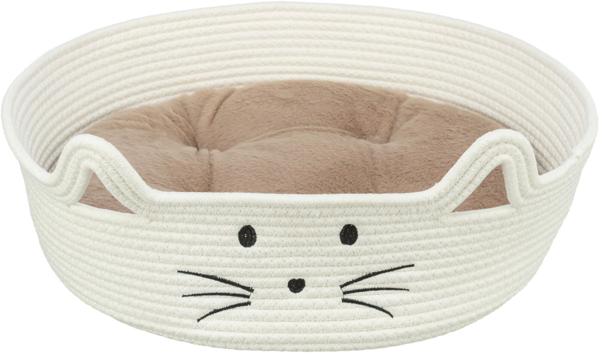 Rundes, weißes Katzenbett mit aufgesticktem Katzengesicht und innen liegendem, beigefarbenem Kissen.