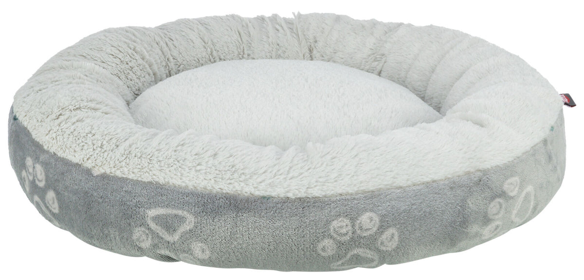 Rundes, flauschiges Tierbett in hellem Grau und Weiß mit Pfotenabdruckmuster auf der Außenseite.