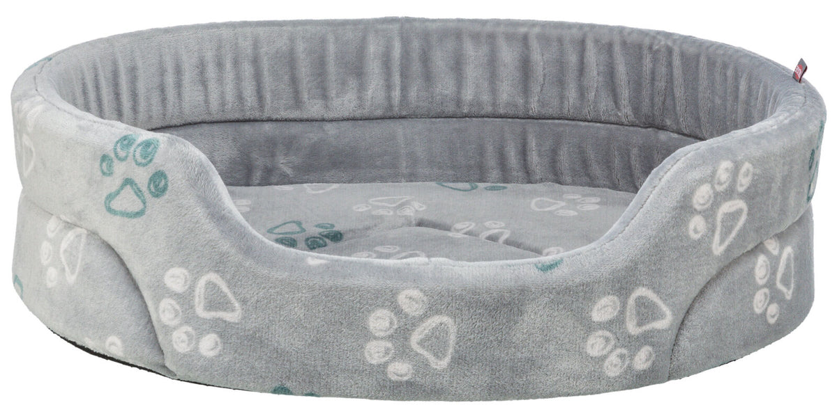 Rundes graues Tierbett mit erhöhtem Rand und Pfotenmuster in Weiß und Grün auf weicher Oberfläche.