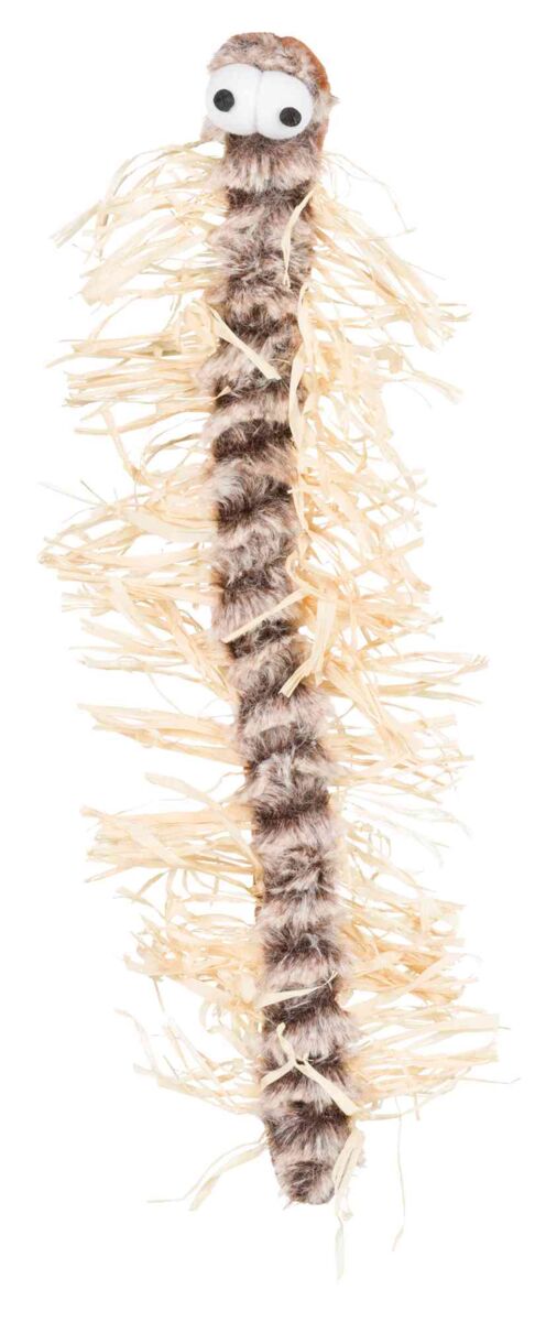 Plüschspielzeug mit großen Augen, behaartem Körper, umgeben von beige Fransen, auf weißem Hintergrund.