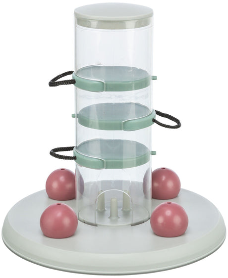 Durchsichtige, zylindrische Vorrichtung mit grünen Halterungen und vier rosa Kugeln auf runder, weißer Basis.