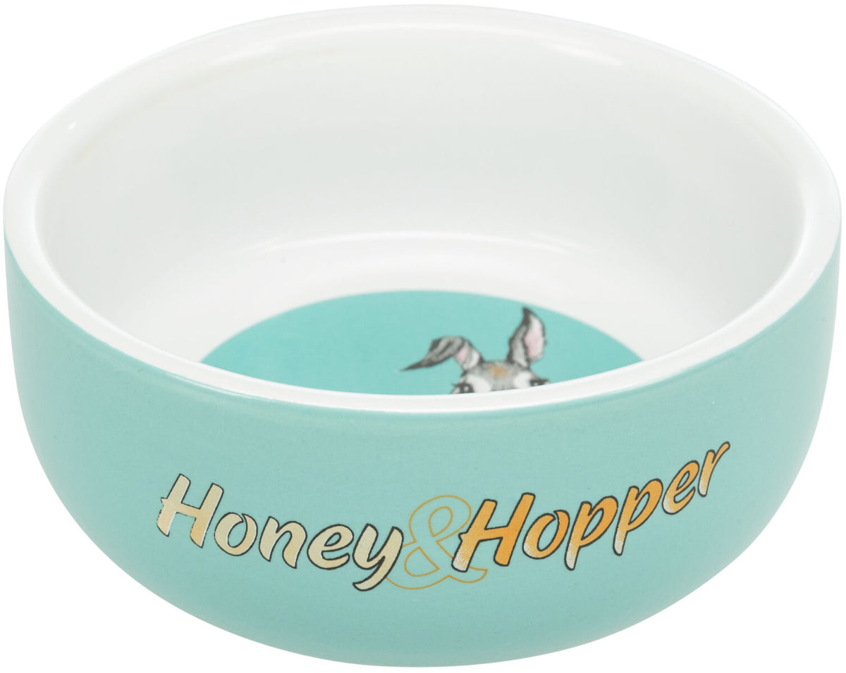 Türkise Schale mit weißem Rand und "Honey &amp; Hopper"-Aufschrift, innen ein Bild mit Tierohren.